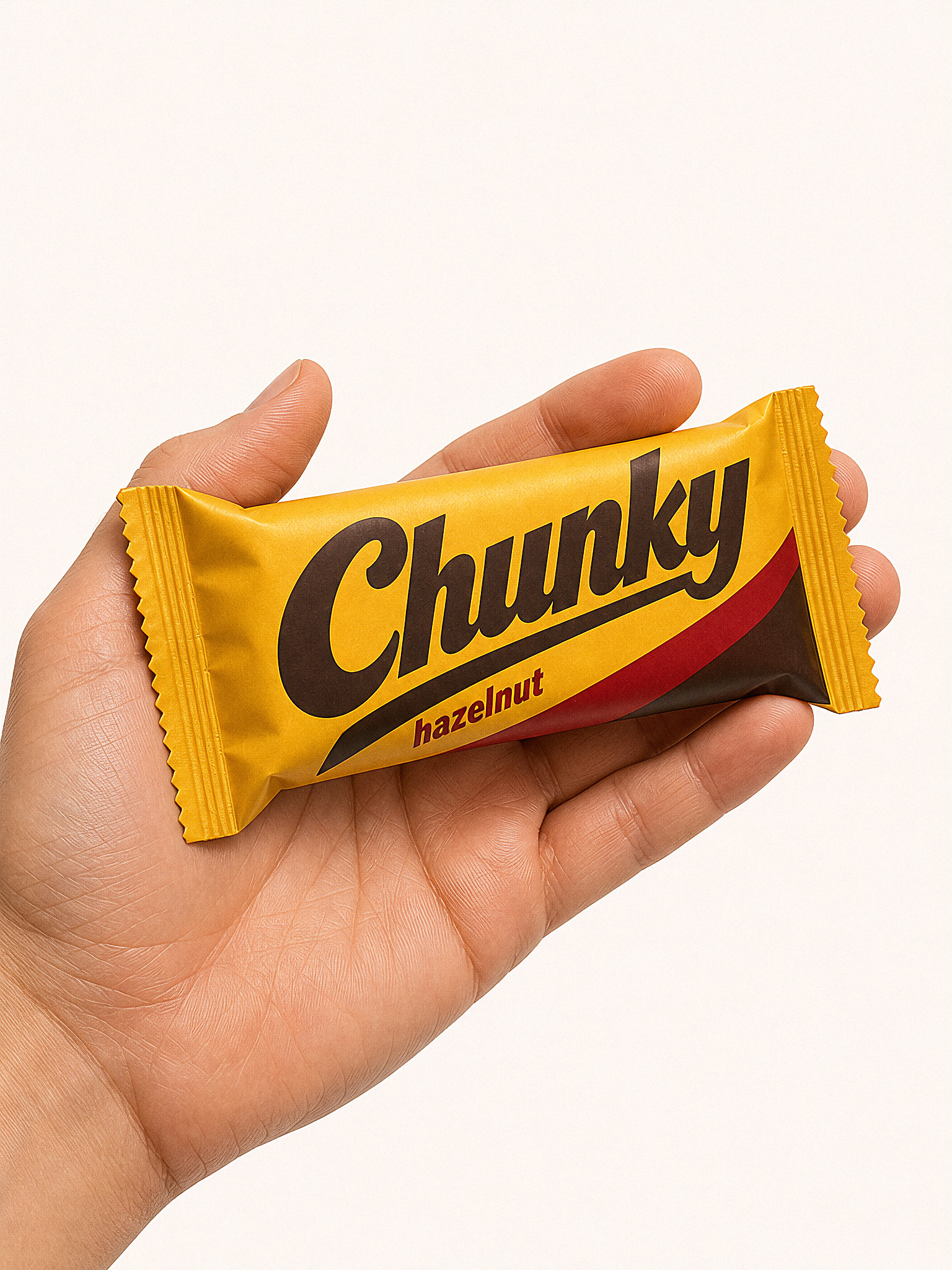 Chunky bar held in a hand to establish its real scale