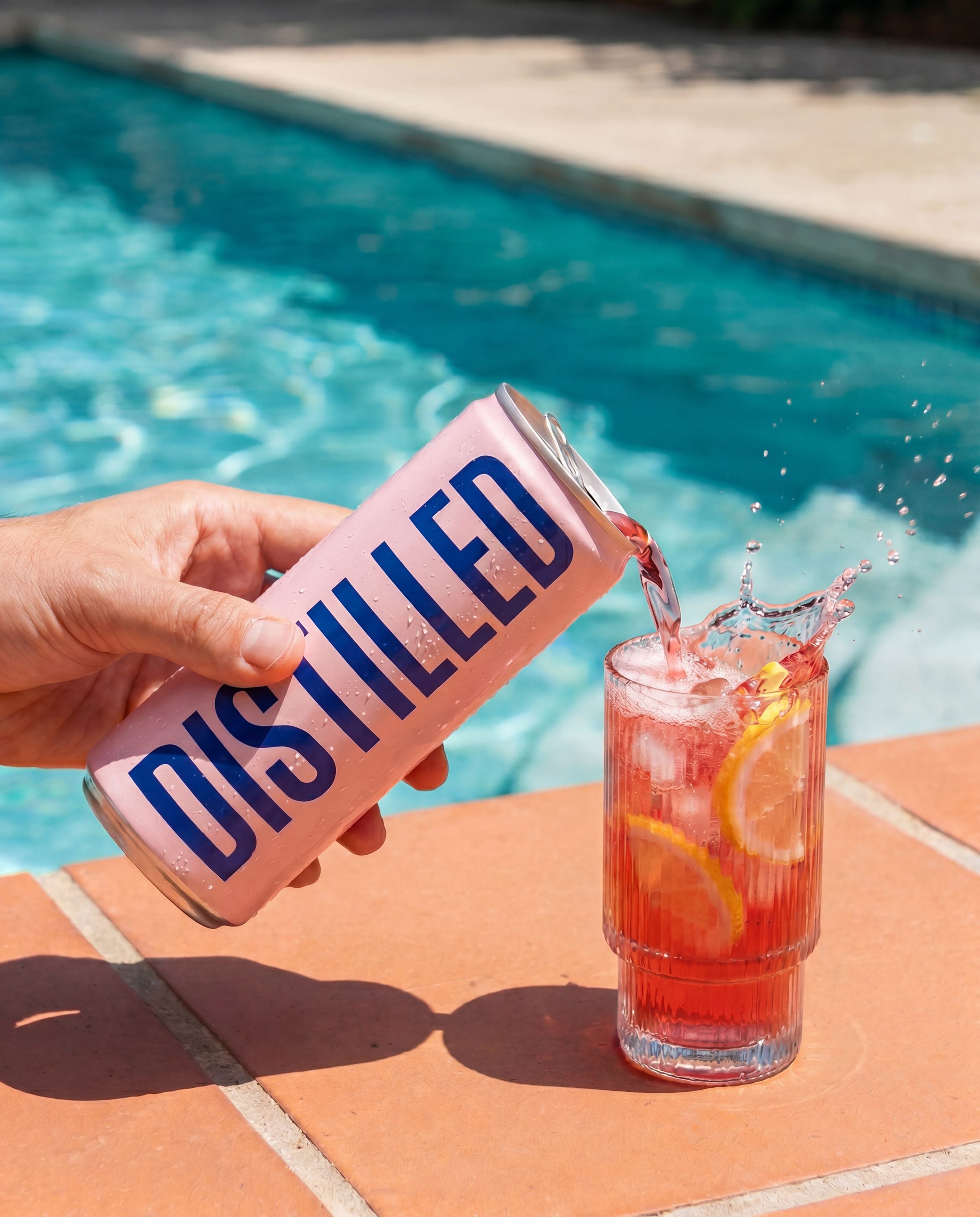The can served poolside beside a cold glass of the botanical drink