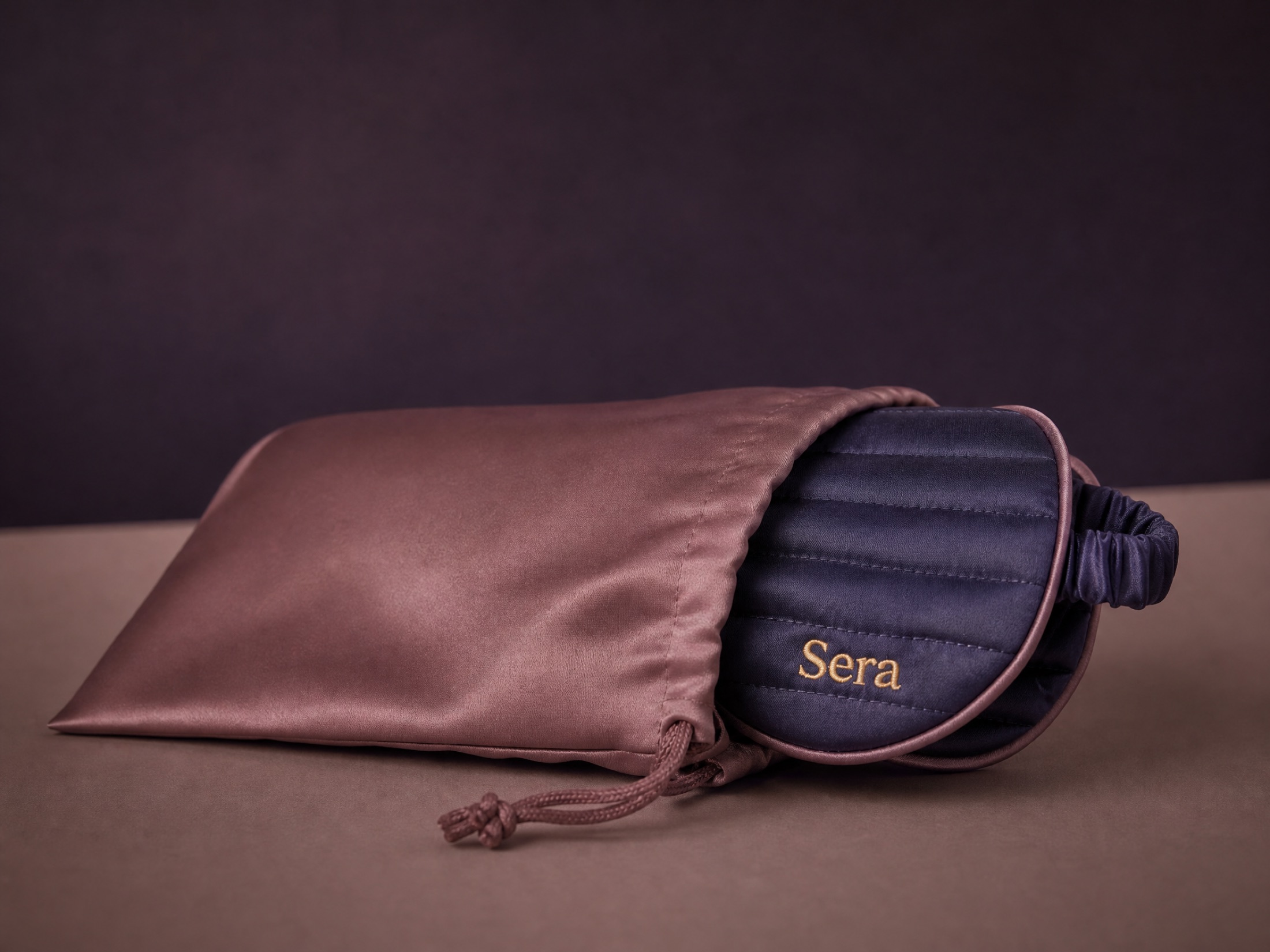 The Sera mask rolled into a soft silk travel pouch