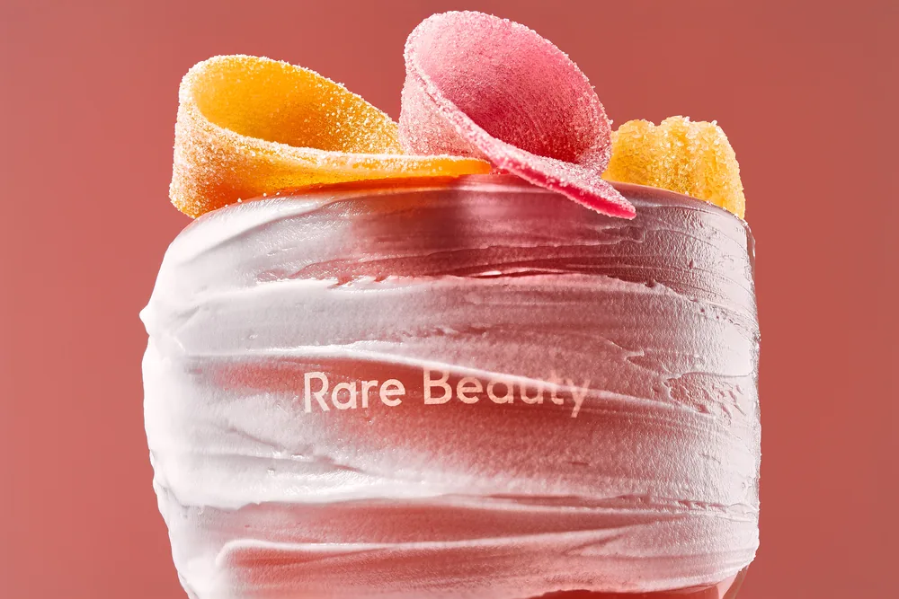 Rare Beauty cream whipped into ridges and topped with pink and yellow candy.